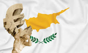 Statue holding crumbling euro symbol in front of Cyprus flag
